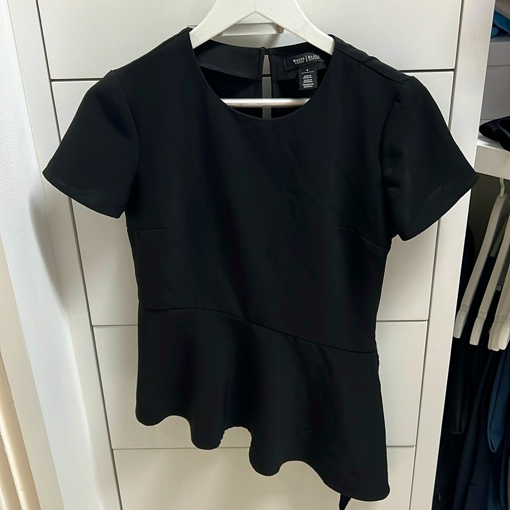 Black top with asymmetrical ruffles, perfect for work